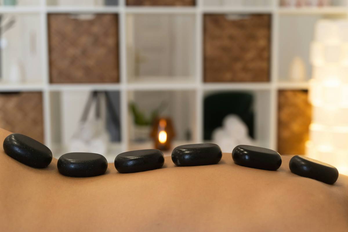 Close-up of hands applying a gentle natural exfoliant scrub are body good on damp skin